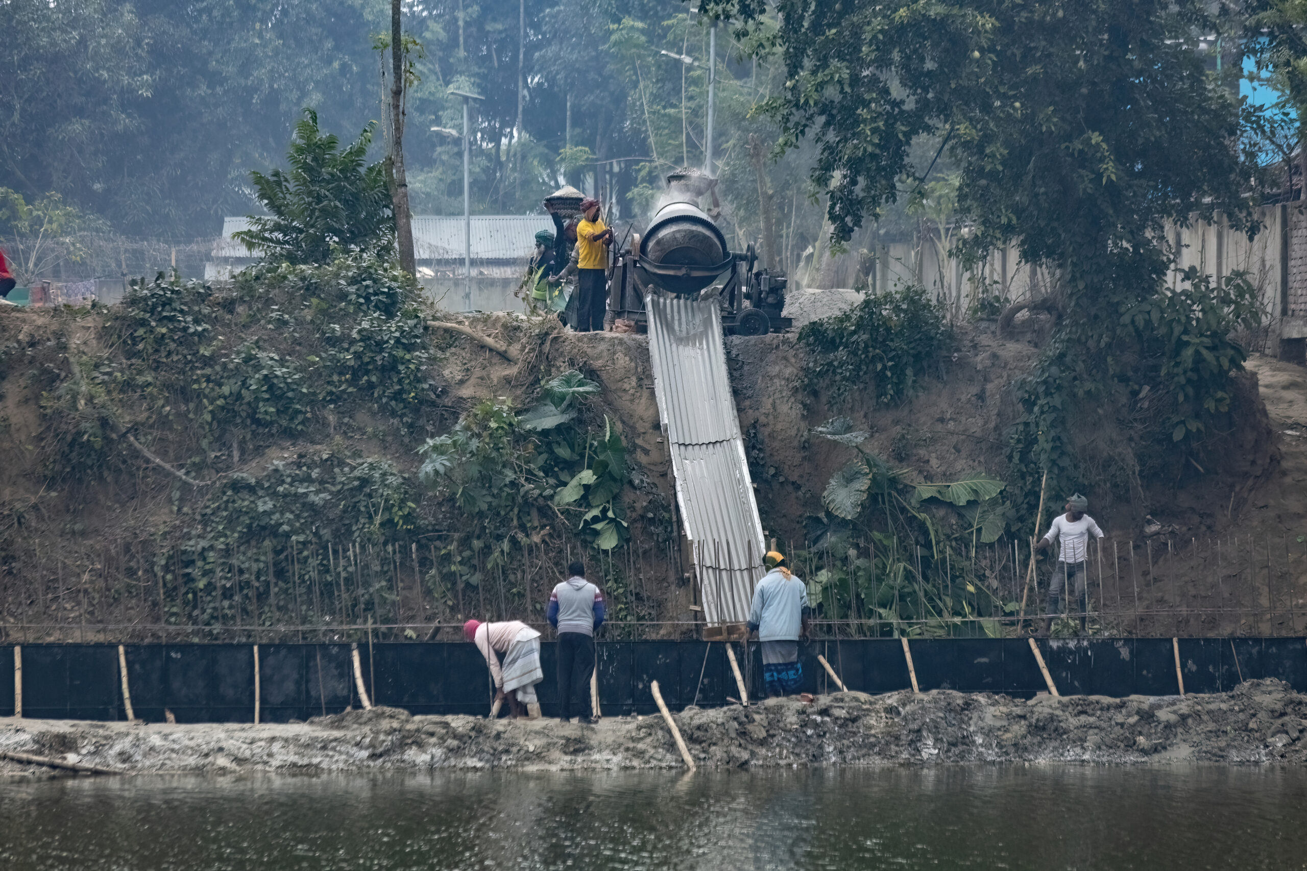Bangladeshi men working on the concrete production in Puthia Bangladesh