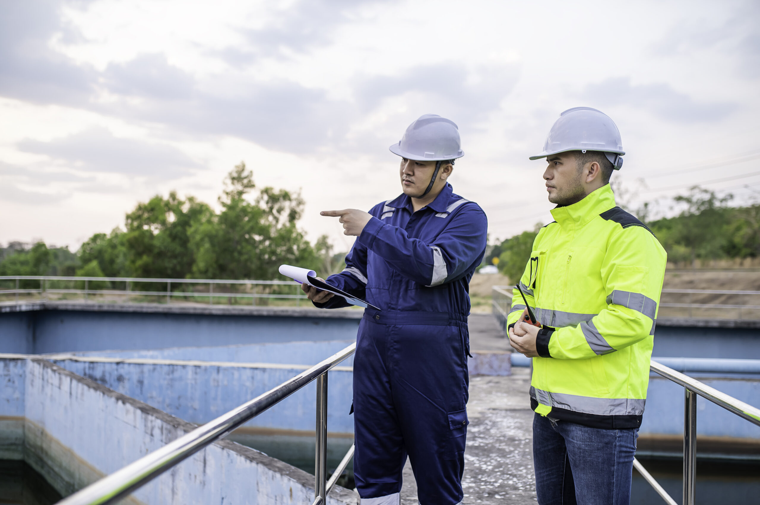 Environmental engineers work at wastewater treatment plants,Water supply engineering working at Water recycling plant for reuse,Technicians and engineers discuss work together.