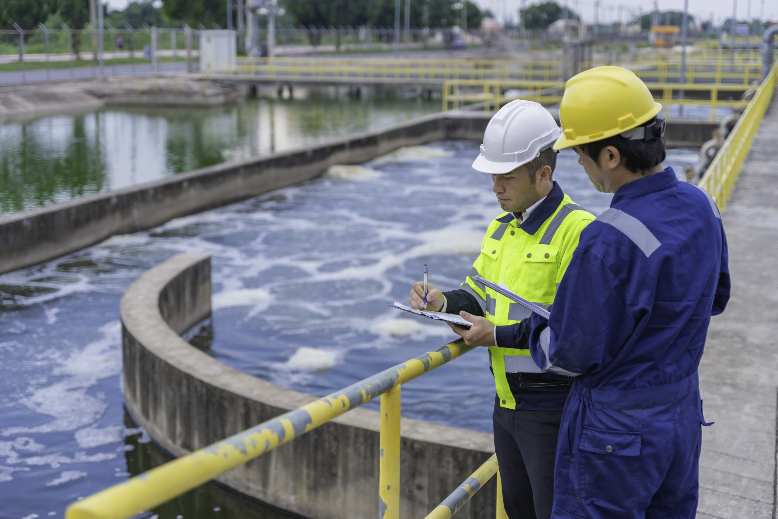 Environmental engineers work at wastewater treatment plants,Water supply engineering working at Water recycling plant for reuse,Technicians and engineers discuss work together.