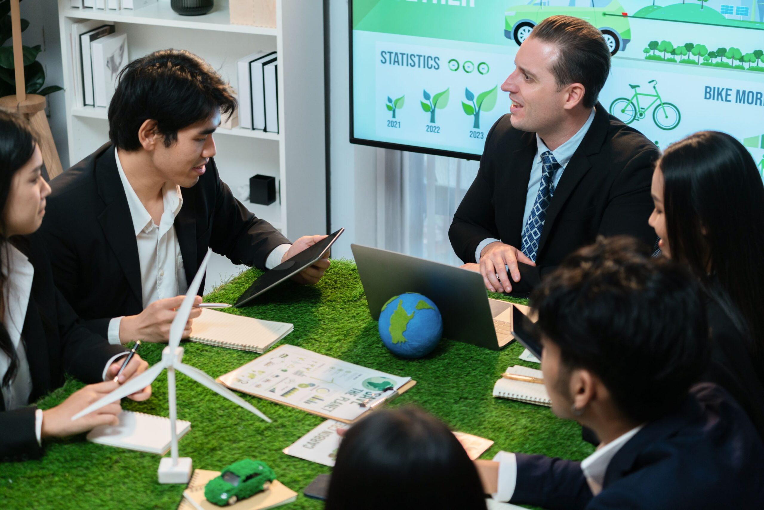 Diverse group of business people planning for alternative energy utilization for greener sustainable Earth by reducing CO2 emission and carbon credit with renewable clean energy technology. Quaint