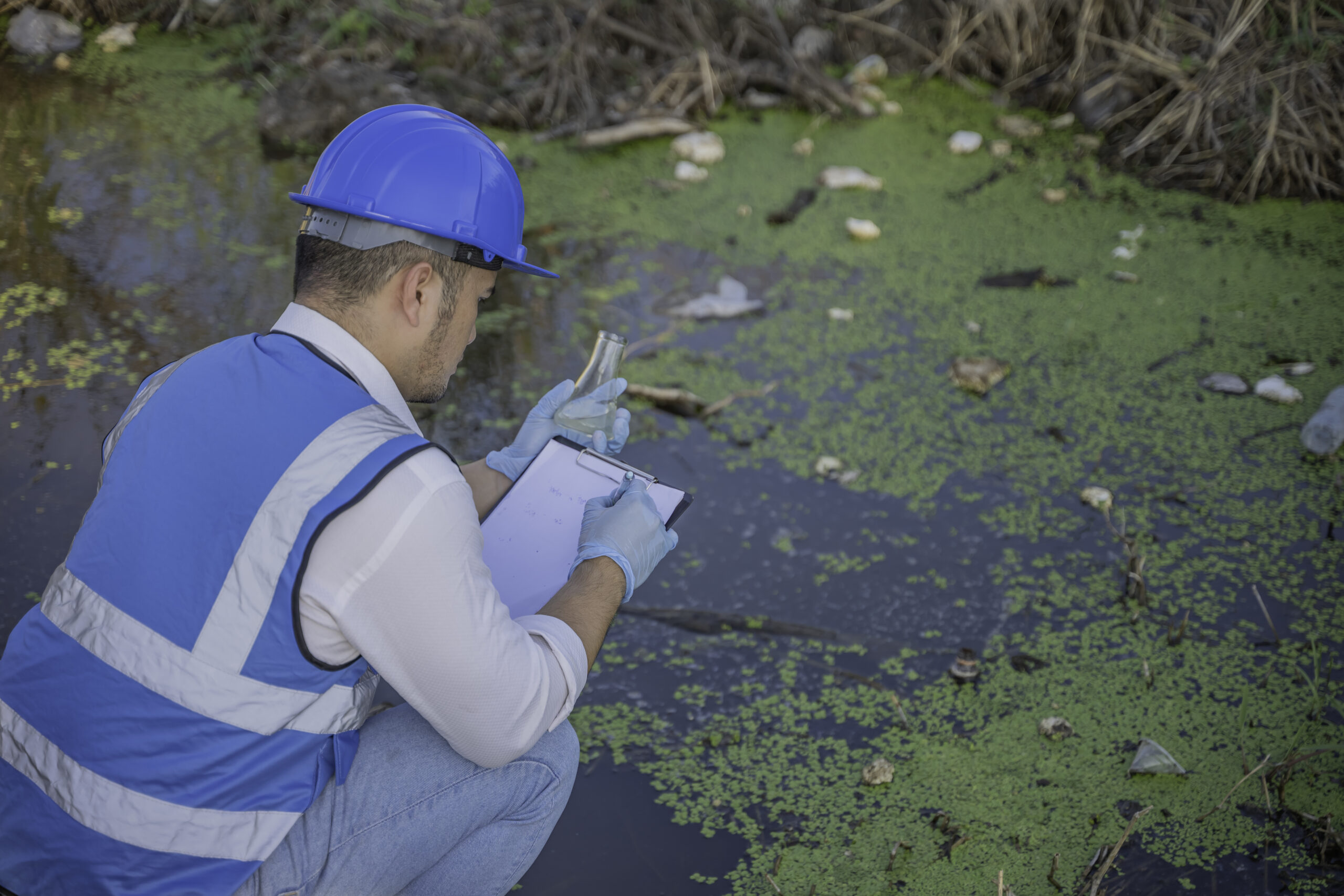 An Environmental Engineer Collects Water Samples from a Polluted Site, Analyzing Contaminants in Community Water Sources, Highlighting Waste Management and Environmental Protection Efforts