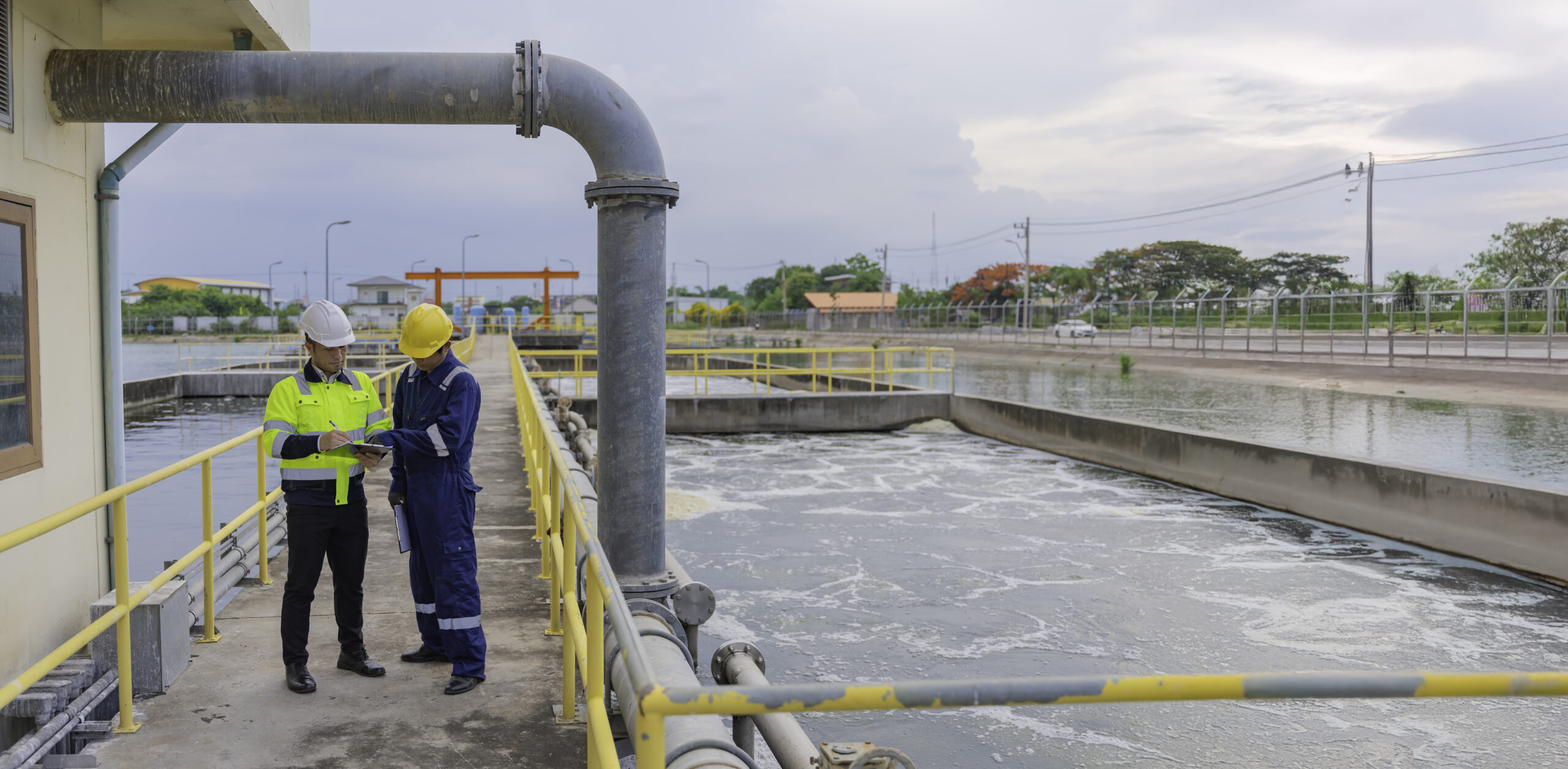 Environmental engineers work at wastewater treatment plants,Water supply engineering working at Water recycling plant for reuse,Technicians and engineers discuss work together.