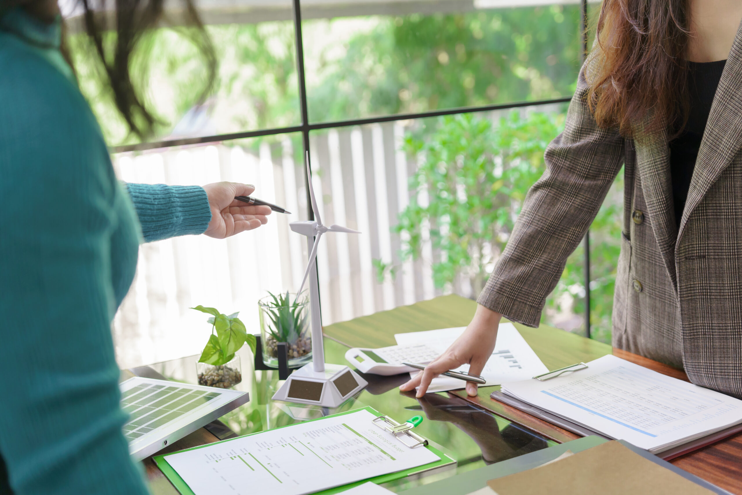 Solar panels green energy Business people working in green eco friendly office business meeting creative ideas for business eco friendly professional teaching corporate people sustainable electricity.