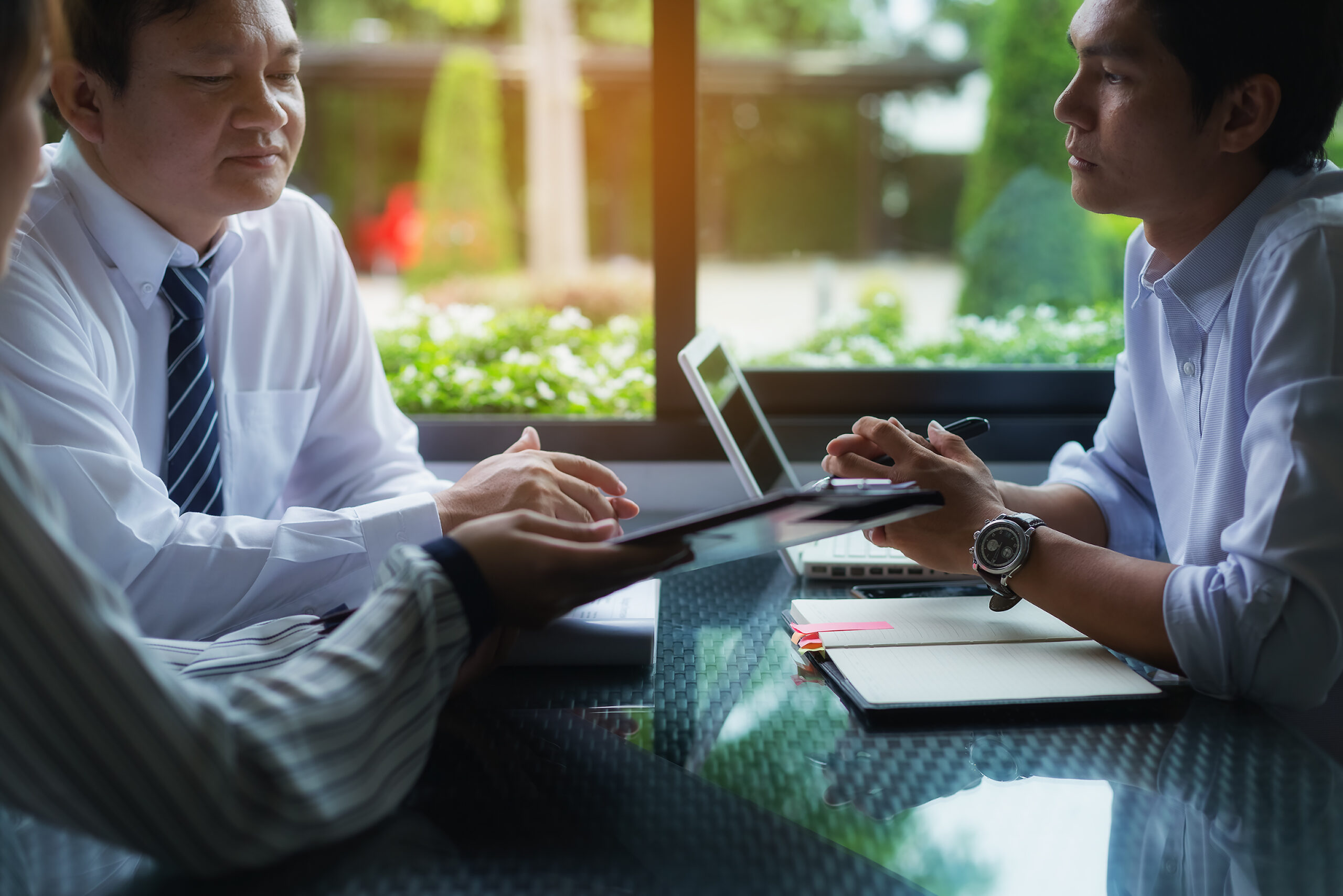 Businessmen negotiate terms and conditions before signing a business co-operation agreement.