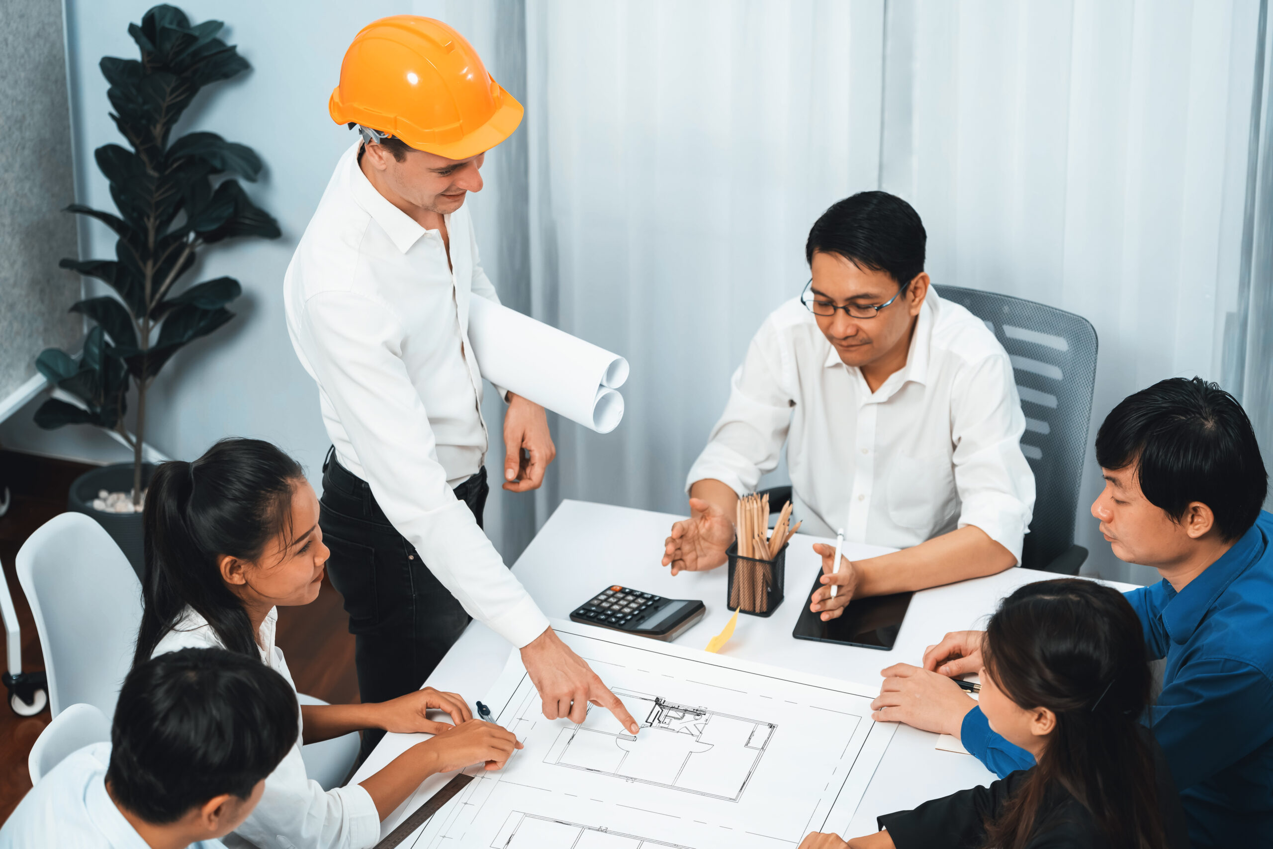 Diverse group of civil engineer and client working together on architectural project, reviewing construction plan and building blueprint at meeting table. Prudent SSUCv3H4sIAAAAAAAACpxTyW7cMAy9F+g/DHyOAO1LfqXogaKkGSGOPfCSogjy76Xt8VS99mKYj+Tj46LP798uly7CXLF7vXxuFtm179d5mWCp40Awf3ngUx5SnlrkY1KWtwDU1sqpLuNUoW/BCAveBnjPBA5r32/w1+7s5gWWdc7zpuUBISz5ShwH+KQ4BP847Mvp2J2UQa6ue2mweY07dkIH+X9lHj8/nw1f84C/d8FNI1PuMxyNPDR2wYC3RXmmk4n0yYqBUobxhFEJJ8HLfFbutA4SDWqmIVGGLJH5ICWTyZeUSijozTM4JycDYmQKc6ZgVMzzQGmIEBGzjFI/gx2PtiRlWTZOMR24YyBAMyusSs4KGbL7K8OBKJkLJrPiTFurmS8ykwxBQMQkjH0GS2E4KOdYKU6QDE0yUCRmpOSgTXGoQiOjZGsgsCiMIeaSWYg0DRPQgHXUtuP7zI9Bd2+/ljy9t4cBa6pjcxMfI0K/BahmD1DvMME/efepYh2uDTIut/2qTyYc12GZtp0+T6Hrx/EOsd9utlCZfOI3mGcKTyfe1EZ6Q+N7U2cYl/0iHqxdotPeTKGUliIop72j+XP9WMDjOdwq8exyTiKy8a2mtqu6Keg8WpuDs4xzj7Rch8wbiywqJ230xQRZaKpffwAAAP//AwBXy/Rx9wMAAA==