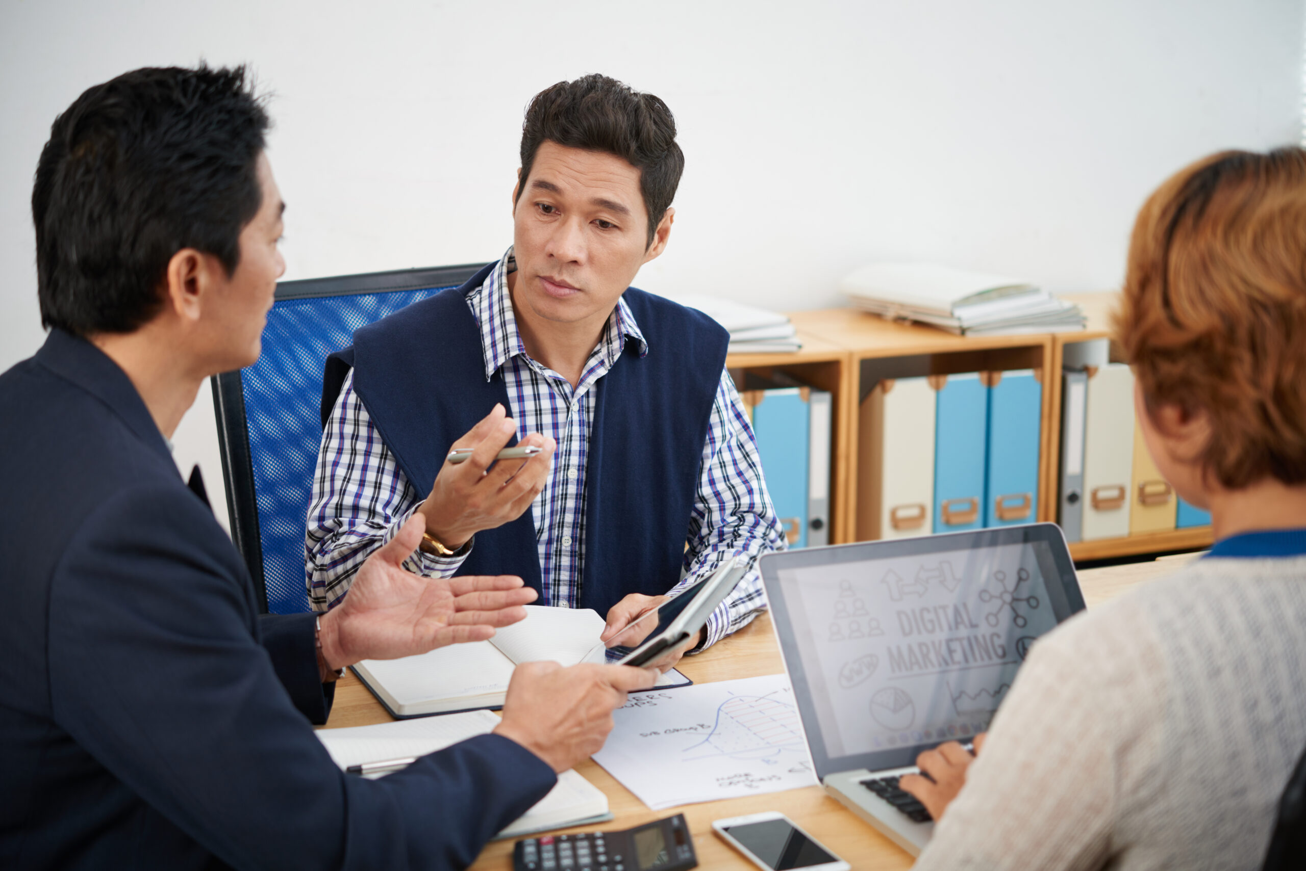 Head of marketing department listening to ideas of colleagues at meeting